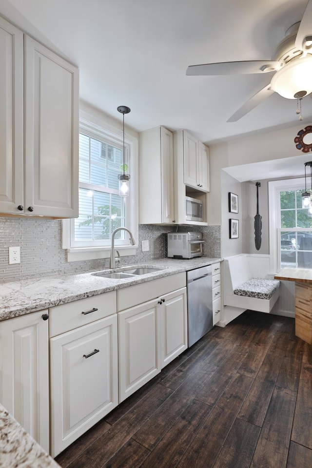 155 Aldrich Rd, Columbus, OH 43214 - kitchen featuring stainless steel appliances, white cabinets, dark wood finished floors, pendant lighting, and tasteful backsplash