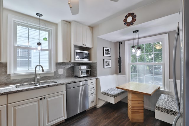 155 Aldrich Rd, Columbus, OH 43214 - kitchen with appliances with stainless steel finishes, dark wood-style floors, healthy amount of natural light, and a wainscoted wall