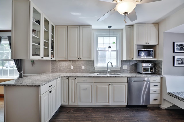 155 Aldrich Rd, Columbus, OH 43214 - kitchen with appliances with stainless steel finishes, glass insert cabinets, light stone counters, and tasteful backsplash