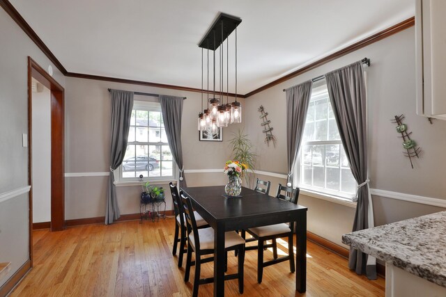 155 Aldrich Rd, Columbus, OH 43214 - dining room with light wood-style flooring, ornamental molding, and a chandelier
