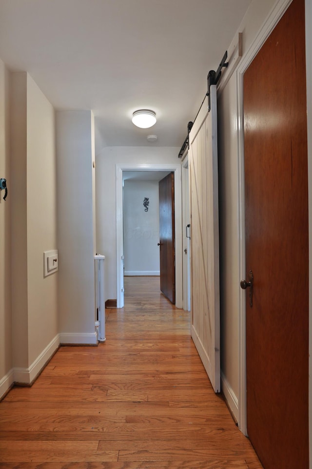 155 Aldrich Rd, Columbus, OH 43214 - hallway with a barn door and light wood finished floors