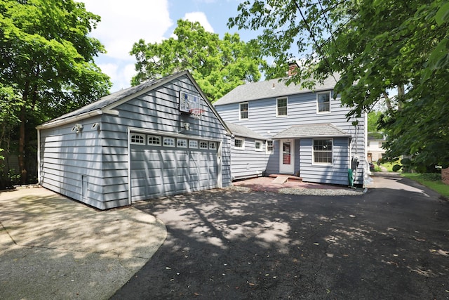 155 Aldrich Rd, Columbus, OH 43214 - view of front of home with an outdoor structure, a chimney, a garage, and a shingled roof