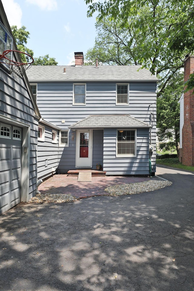 155 Aldrich Rd, Columbus, OH 43214 - view of front of house featuring a chimney and a garage