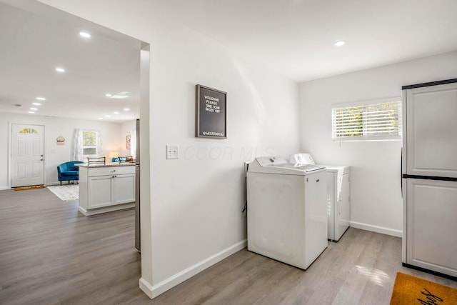 1997 Ferris Rd, Columbus, OH 43224 - washroom featuring washing machine and dryer, light wood finished floors, plenty of natural light, baseboards, and recessed lighting