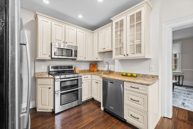 145 E Sycamore St, Columbus, OH 43206 - kitchen with appliances with stainless steel finishes, dark wood-style flooring, a sink, light stone counters, and recessed lighting