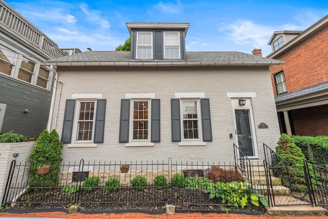 145 E Sycamore St, Columbus, OH 43206 - view of front facade with a fenced front yard, brick siding, and entry steps