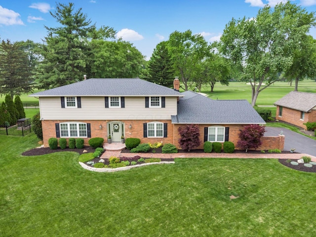 1360 Clubview Blvd S, Columbus, OH 43235 - colonial home with a front yard, a chimney, and brick siding