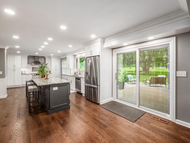 1360 Clubview Blvd S, Columbus, OH 43235 - kitchen with appliances with stainless steel finishes, ornamental molding, white cabinetry, tasteful backsplash, and a kitchen island