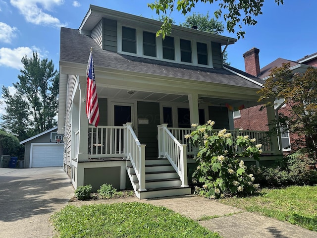 135 Richards Rd, Columbus, OH 43214 - bungalow-style home with covered porch, an outdoor structure, roof with shingles, and a garage