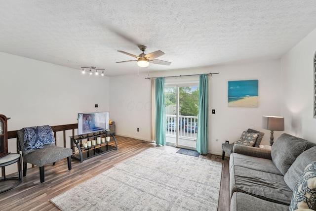 2422 Briers Dr Unit D, Columbus, OH 43209 - living area featuring ceiling fan, wood finished floors, baseboards, and a textured ceiling