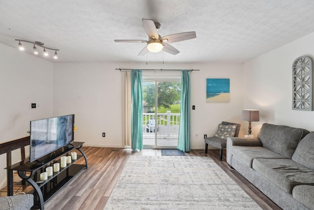 2422 Briers Dr Unit D, Columbus, OH 43209 - living room with ceiling fan, wood finished floors, a textured ceiling, and baseboards