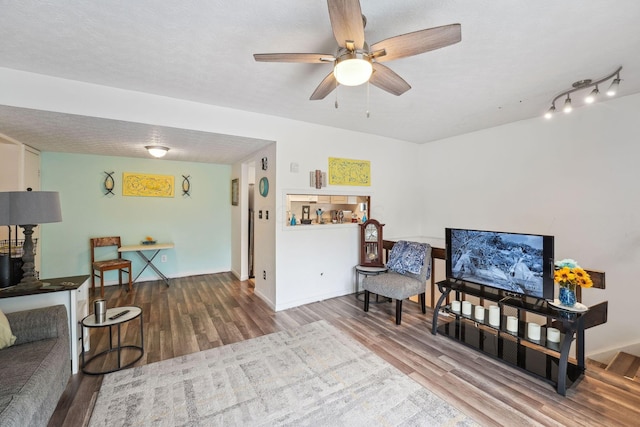 2422 Briers Dr Unit D, Columbus, OH 43209 - living area featuring wood finished floors, ceiling fan, and baseboards