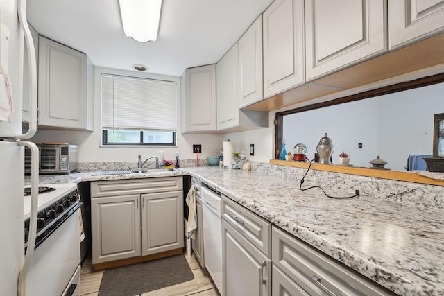 2422 Briers Dr Unit D, Columbus, OH 43209 - kitchen featuring white appliances, a sink, light stone countertops, and light wood-style flooring