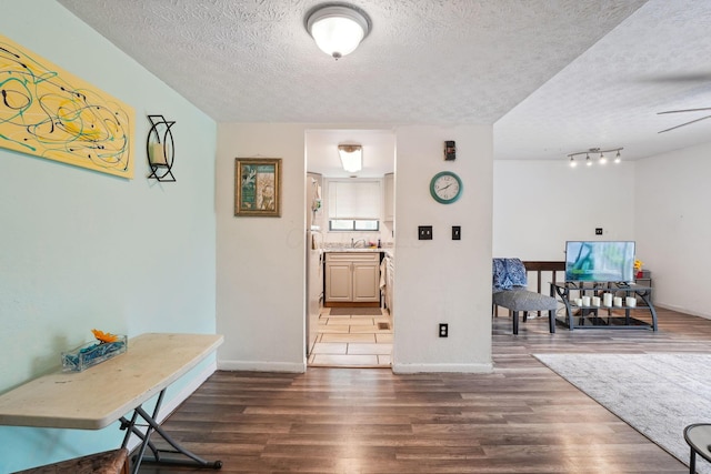 2422 Briers Dr Unit D, Columbus, OH 43209 - foyer entrance featuring a textured ceiling, dark wood-style floors, and baseboards