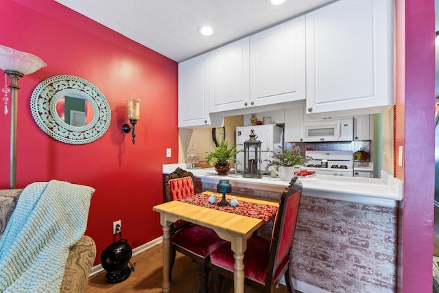 4655 Athalia Dr Unit 20B, Columbus, OH 43228 - kitchen featuring white microwave, range, refrigerator, white cabinets, and recessed lighting