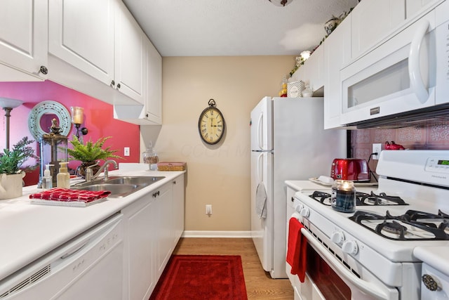 4655 Athalia Dr Unit 20B, Columbus, OH 43228 - kitchen featuring white appliances, a sink, light countertops, light wood-type flooring, and white cabinetry