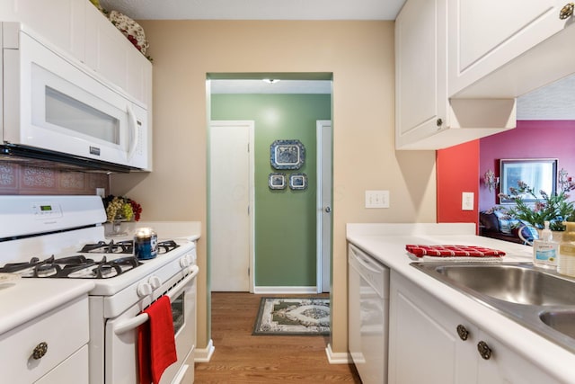 4655 Athalia Dr Unit 20B, Columbus, OH 43228 - kitchen with white appliances, light wood-style floors, light countertops, and white cabinetry