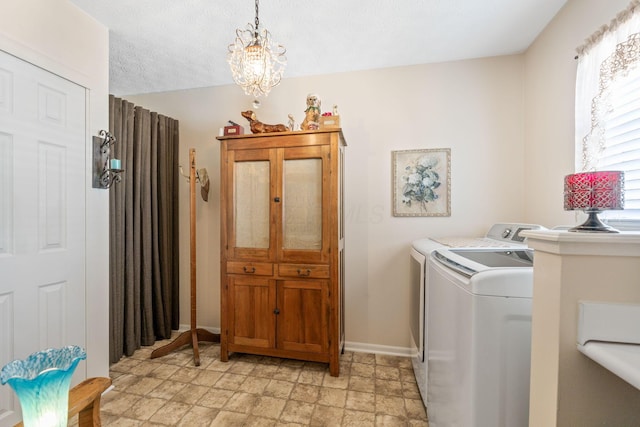 4655 Athalia Dr Unit 20B, Columbus, OH 43228 - laundry area with washer and dryer, baseboards, a chandelier, stone finish floors, and a textured ceiling