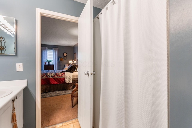 4655 Athalia Dr Unit 20B, Columbus, OH 43228 - ensuite bathroom with vanity, a shower with curtain, and a textured ceiling