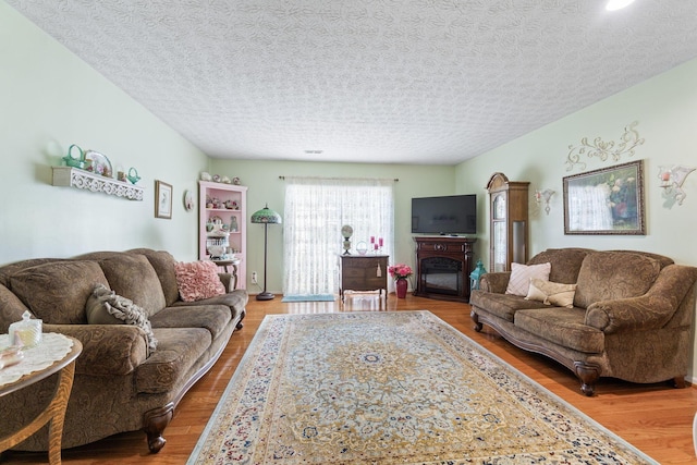 4714 Athalia Dr Unit 26B, Columbus, OH 43228 - living room with wood finished floors, a glass covered fireplace, and recessed lighting