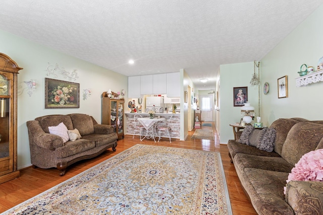 4714 Athalia Dr Unit 26B, Columbus, OH 43228 - living area with wood finished floors and a textured ceiling