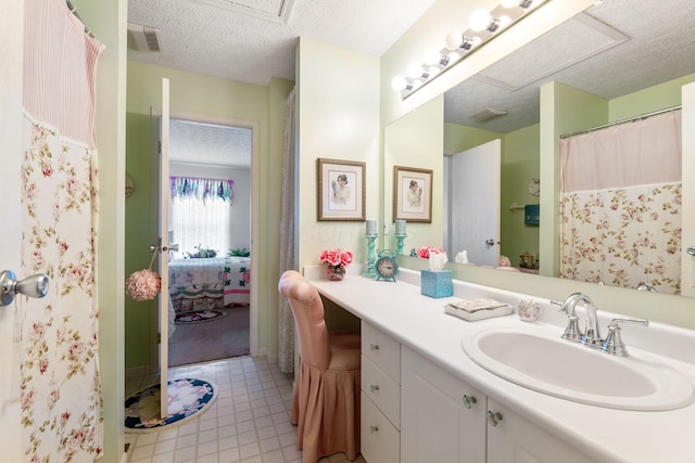 4714 Athalia Dr Unit 26B, Columbus, OH 43228 - bathroom featuring vanity, connected bathroom, a textured ceiling, and tile patterned flooring
