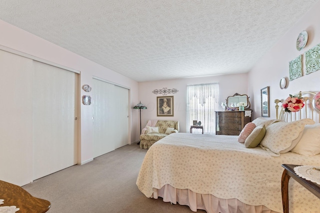 4714 Athalia Dr Unit 26B, Columbus, OH 43228 - bedroom featuring carpet, multiple closets, and a textured ceiling