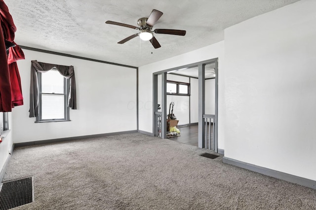 421 E Main St, Newark, OH 43055 - carpeted spare room featuring a textured ceiling, a ceiling fan, and baseboards