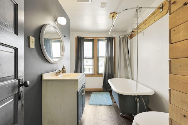 421 E Main St, Newark, OH 43055 - full bath featuring a soaking tub, vanity, wood finished floors, toilet, and a shower with shower curtain