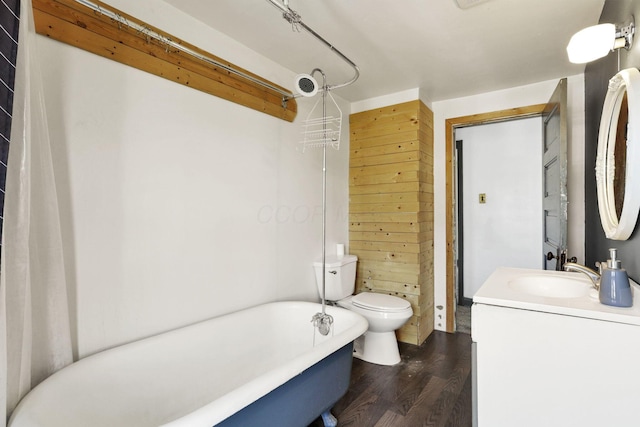 421 E Main St, Newark, OH 43055 - full bathroom featuring wood finished floors, a freestanding bath, vanity, toilet, and wooden walls