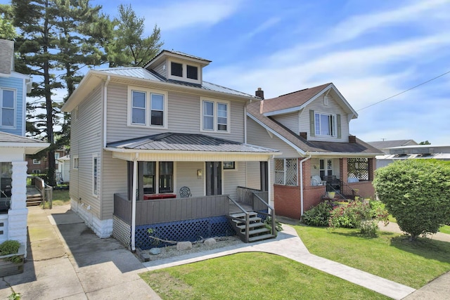 421 E Main St, Newark, OH 43055 - traditional style home featuring a porch, metal roof, a front yard, and a standing seam roof