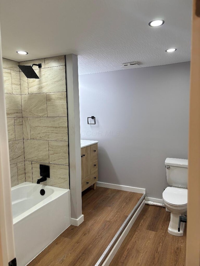 418 Clinton St, Circleville, OH 43113 - full bathroom with wood finished floors, toilet, shower / tub combination, vanity, and recessed lighting