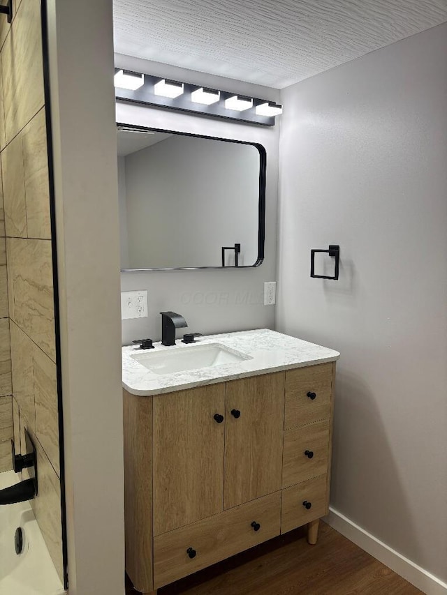 418 Clinton St, Circleville, OH 43113 - full bathroom with vanity, wood finished floors, and baseboards