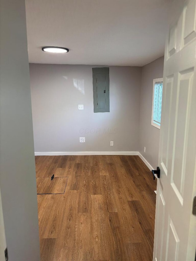418 Clinton St, Circleville, OH 43113 - spare room featuring electric panel, dark wood-style flooring, and baseboards