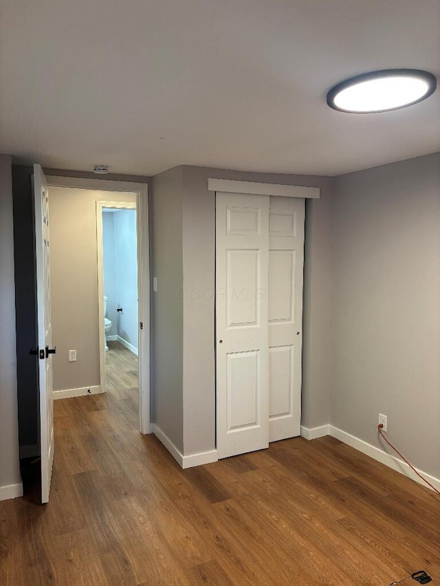 418 Clinton St, Circleville, OH 43113 - unfurnished bedroom featuring wood finished floors, baseboards, and a closet