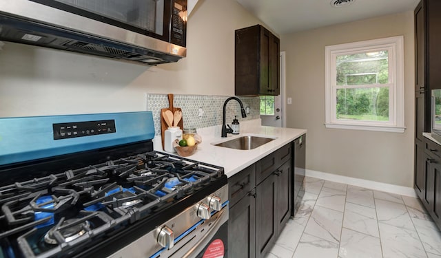 2474 Mecca Rd, Columbus, OH 43224 - kitchen with appliances with stainless steel finishes, a sink, light marble finish floors, baseboards, and backsplash