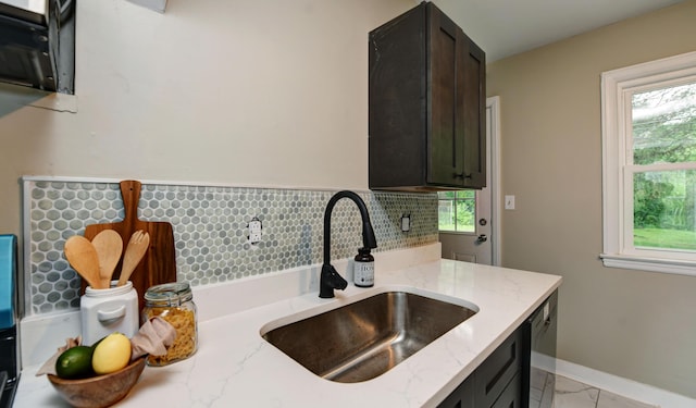 2474 Mecca Rd, Columbus, OH 43224 - kitchen with a sink, light stone countertops, dishwasher, light marble finish flooring, and baseboards