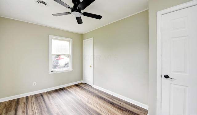 2474 Mecca Rd, Columbus, OH 43224 - spare room featuring wood finished floors, a ceiling fan, baseboards, and crown molding