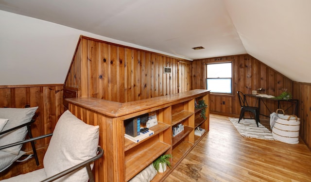 2474 Mecca Rd, Columbus, OH 43224 - bonus room with wood walls, light wood-type flooring, and vaulted ceiling