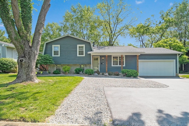 5770 Linworth Rd, Columbus, OH 43235 - tri-level home featuring concrete driveway, an attached garage, a front lawn, and stone siding