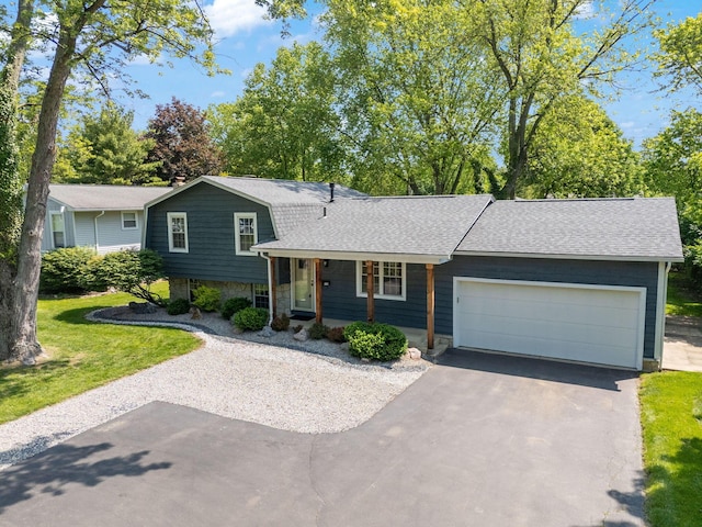 5770 Linworth Rd, Columbus, OH 43235 - tri-level home featuring driveway, a shingled roof, an attached garage, a front yard, and stone siding