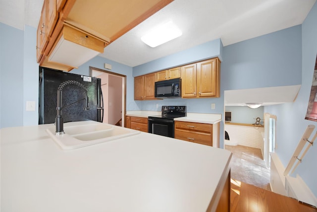 5770 Linworth Rd, Columbus, OH 43235 - kitchen with black appliances, light countertops, a sink, and light colored carpet