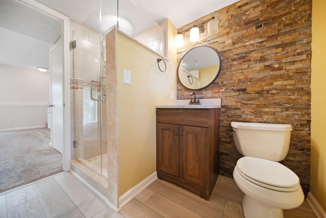 5770 Linworth Rd, Columbus, OH 43235 - full bath with vanity, a shower stall, wood finished floors, and toilet