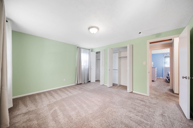 5770 Linworth Rd, Columbus, OH 43235 - unfurnished bedroom featuring two closets, carpet floors, and baseboards