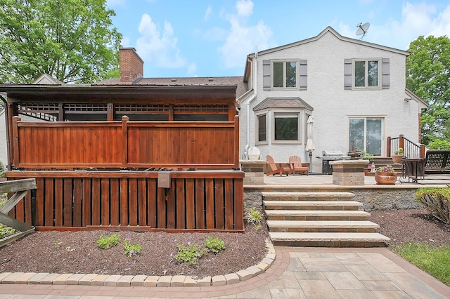 1059 Circle On The Grn, Columbus, OH 43235 - view of front of home featuring a chimney, a patio, and stucco siding
