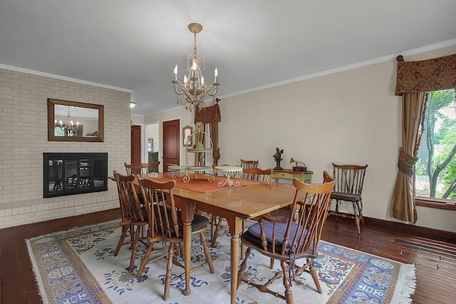 1059 Circle On The Grn, Columbus, OH 43235 - dining room featuring a chandelier, hardwood / wood-style floors, ornamental molding, and a brick fireplace