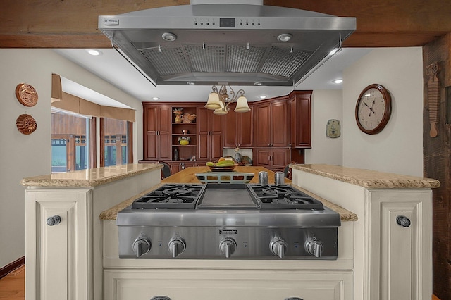 1059 Circle On The Grn, Columbus, OH 43235 - kitchen with stainless steel gas stovetop, wall chimney exhaust hood, open shelves, light stone counters, and pendant lighting