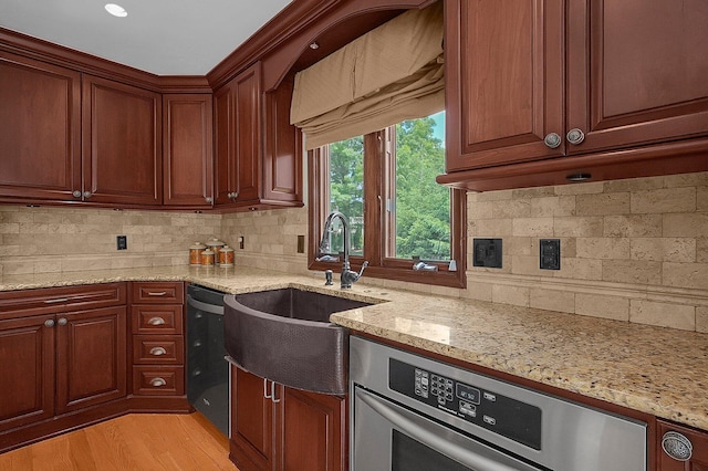 1059 Circle On The Grn, Columbus, OH 43235 - kitchen with dishwashing machine, stainless steel oven, light stone counters, and tasteful backsplash