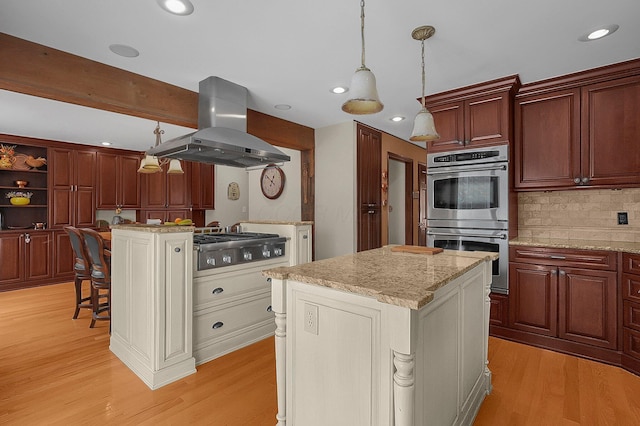 1059 Circle On The Grn, Columbus, OH 43235 - kitchen with island range hood, stainless steel appliances, a center island, light wood finished floors, and recessed lighting