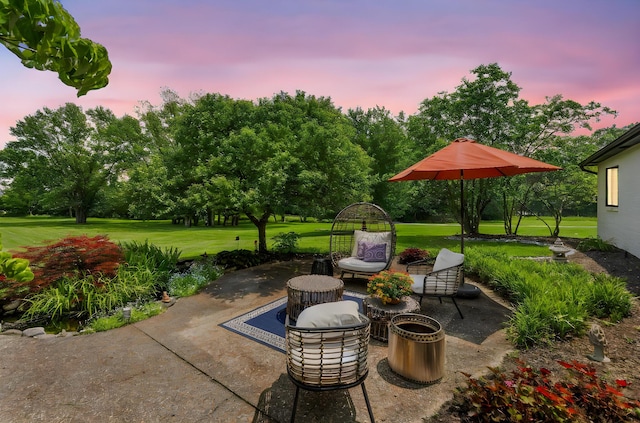 3515 Babbitt Rd, Blacklick, OH 43004 - patio terrace at dusk with a patio, a lawn, and view of wooded area